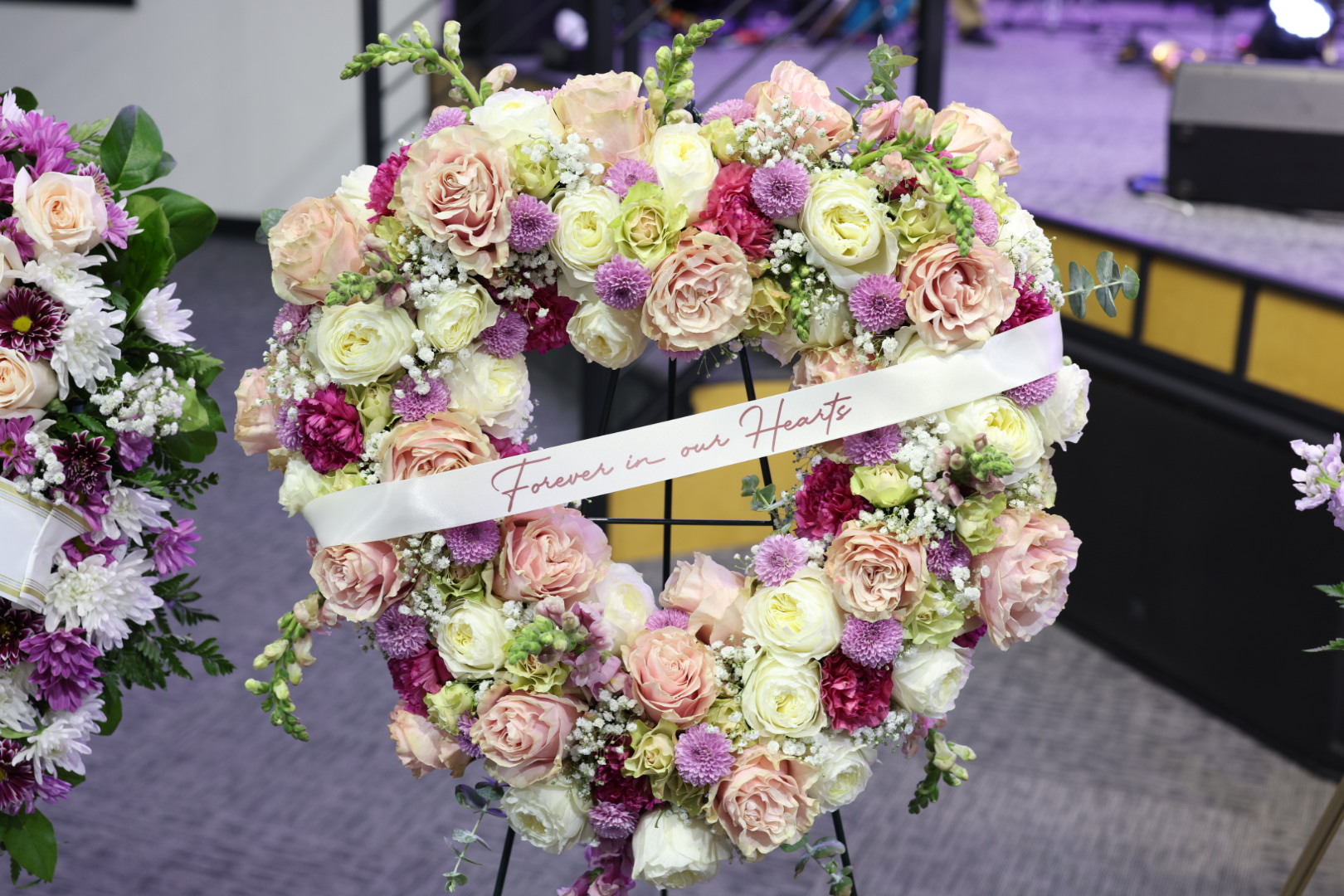 Heart-shaped sympathy wreath with a Forever in our Hearts ribbon